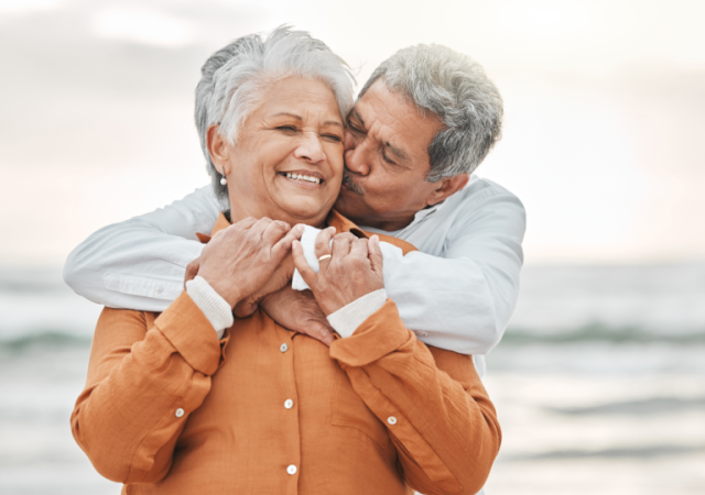 older couple happy on the beach